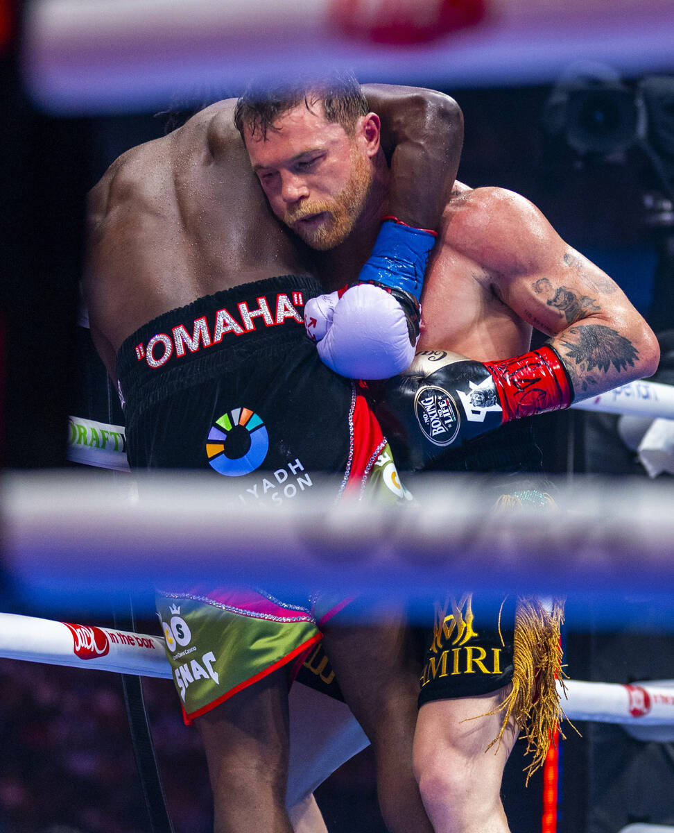 Canelo Alvarez and Terence Crawford tangle up during their undisputed super middleweight champi ...