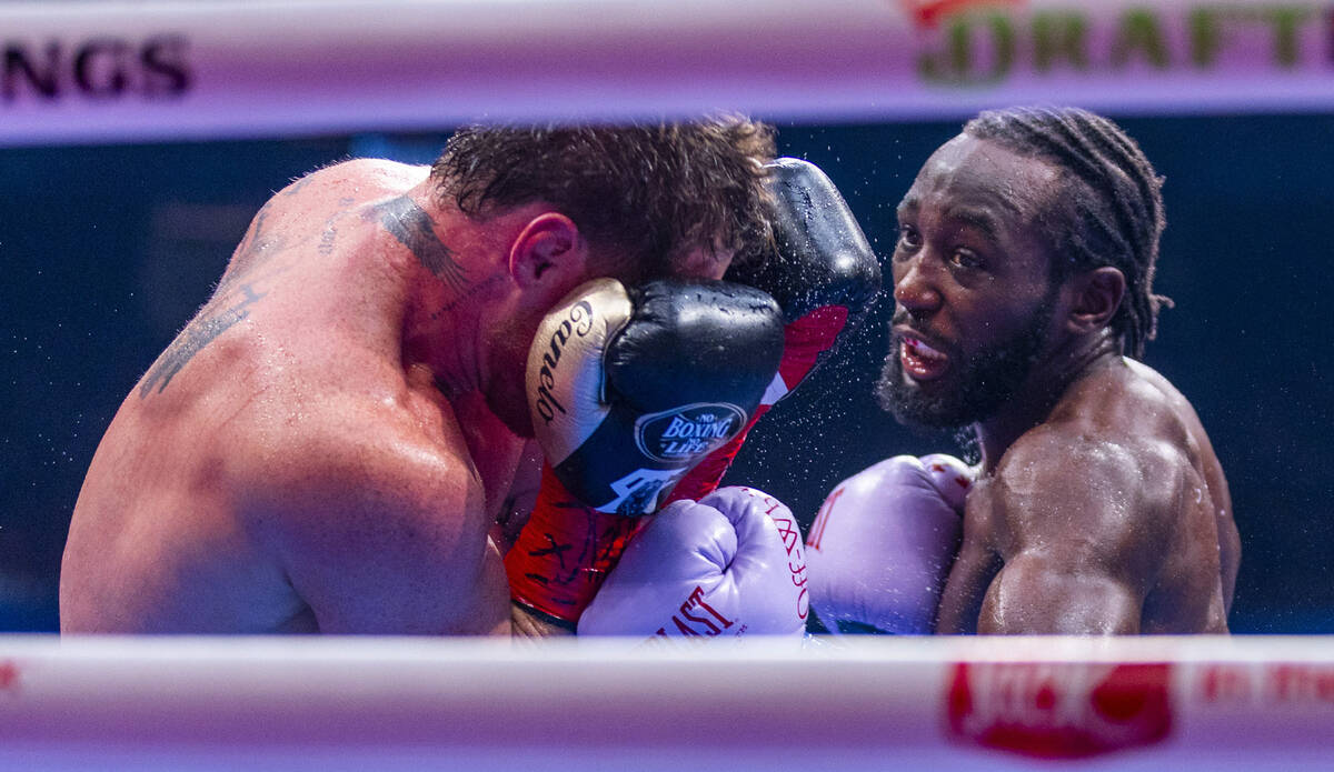 Canelo Alvarez covers up as Terence Crawford throws another punch during their undisputed super ...