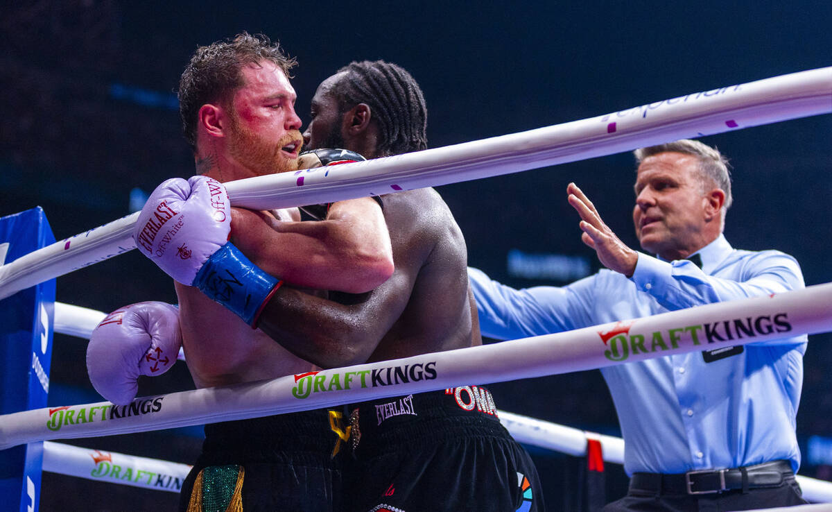 Canelo Alvarez and Terence Crawford tangle up during their undisputed super middleweight champi ...
