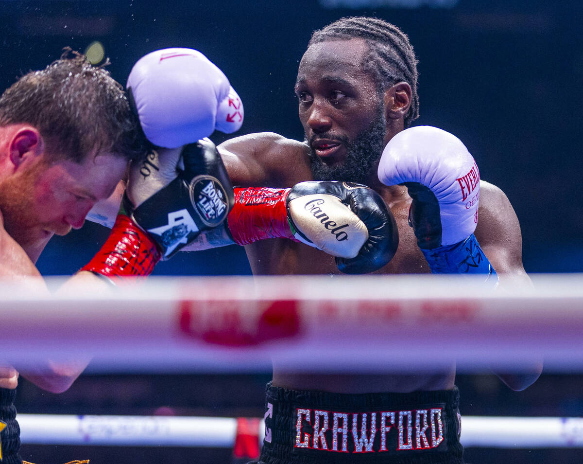 Canelo Alvarez has a punch graze his head from Terence Crawford during their undisputed super m ...