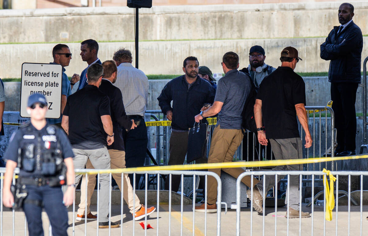 FBI Director Kash Patel, center, arrives at the scene of the shooting death of Charlie Kirk at ...