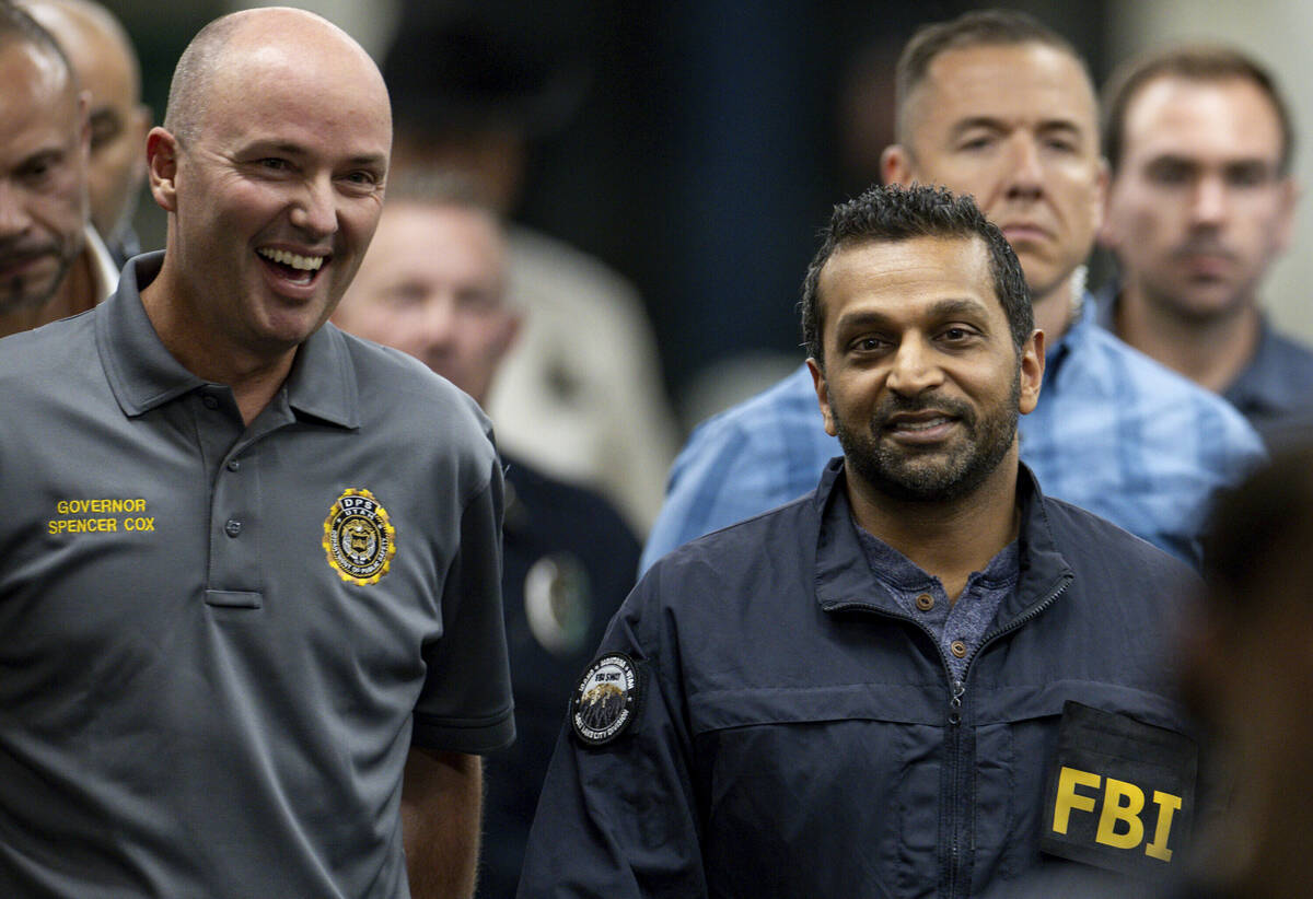 Utah Gov. Spencer Cox, left, and FBI Director Kash Patel, right, converse as they make their wa ...