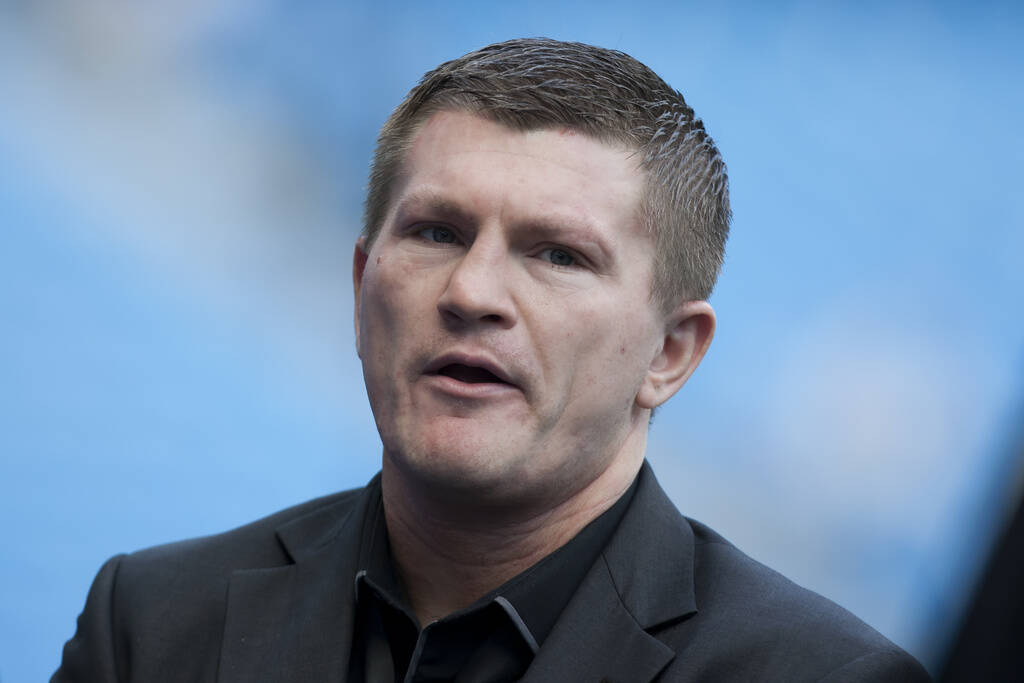 Boxer Ricky Hatton stands by the pitch before Manchester City's English Premier League soccer m ...