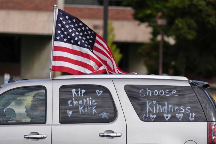 A vehicle marked with messages written on its windows in tribute to Turning Point USA CEO and c ...