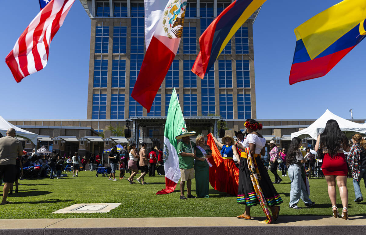 Attendees gather for photos during the fifth annual kickoff celebration for Hispanic Heritage M ...