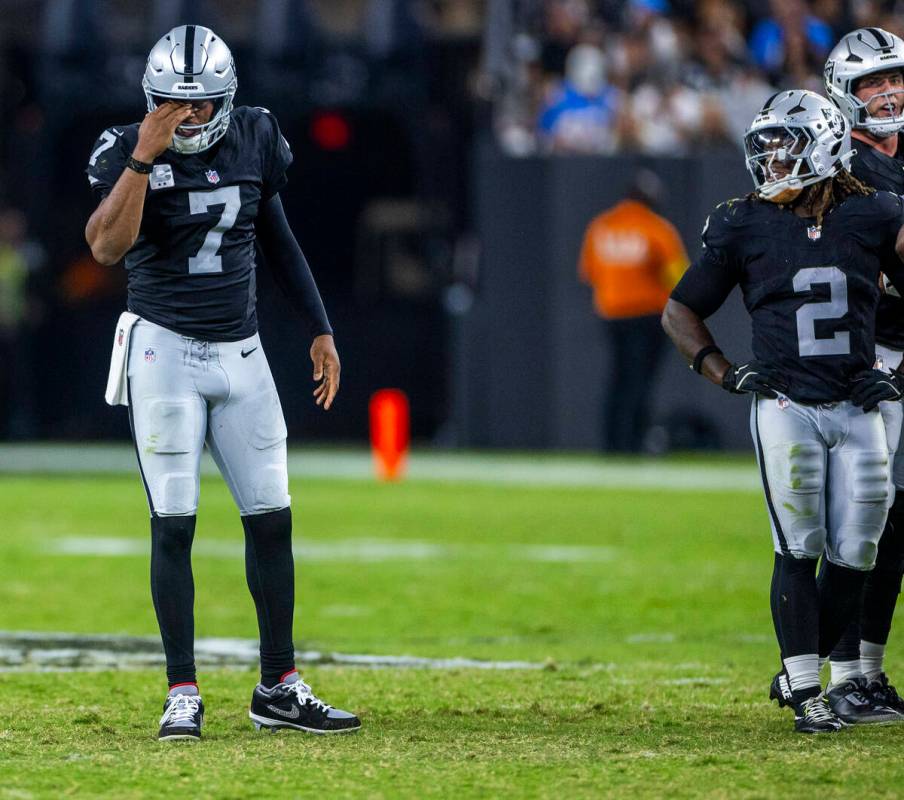 Raiders quarterback Geno Smith (7) takes a minute after another shot to the turf from the Los A ...