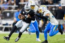 Raiders quarterback Geno Smith (7) runs down field against Los Angeles Chargers safety Alohi Gi ...
