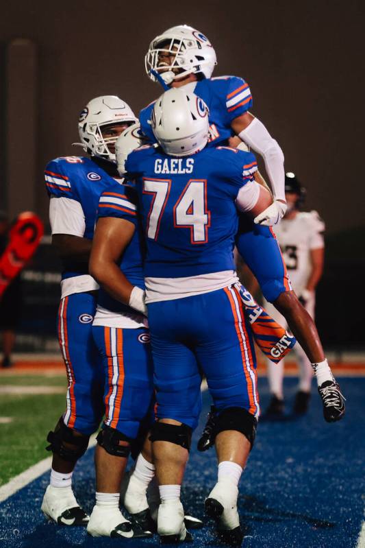 Bishop Gorman teammates celebrate a touchdown by Isaiah Nickels (1) during a high school foot ...
