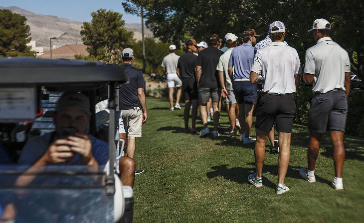 Golden Knights players walk to their carts before the start of the Golden Knights' annual ...