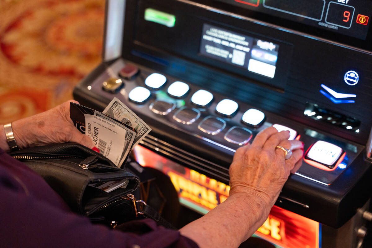 A tourist from Salt Lake City, who asked not to be identified, plays a slot machine at the Casa ...