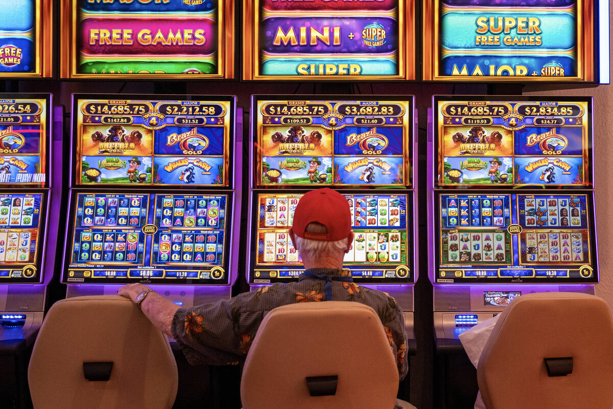 A guest plays a slot machine at the CasaBlanca Resort and Casino in Mesquite, Nev Sept. 10, 202 ...
