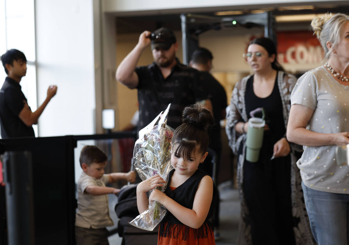 Attendees make their way inside before the start of a vigil for Charlie Kirk hosted by Turning ...