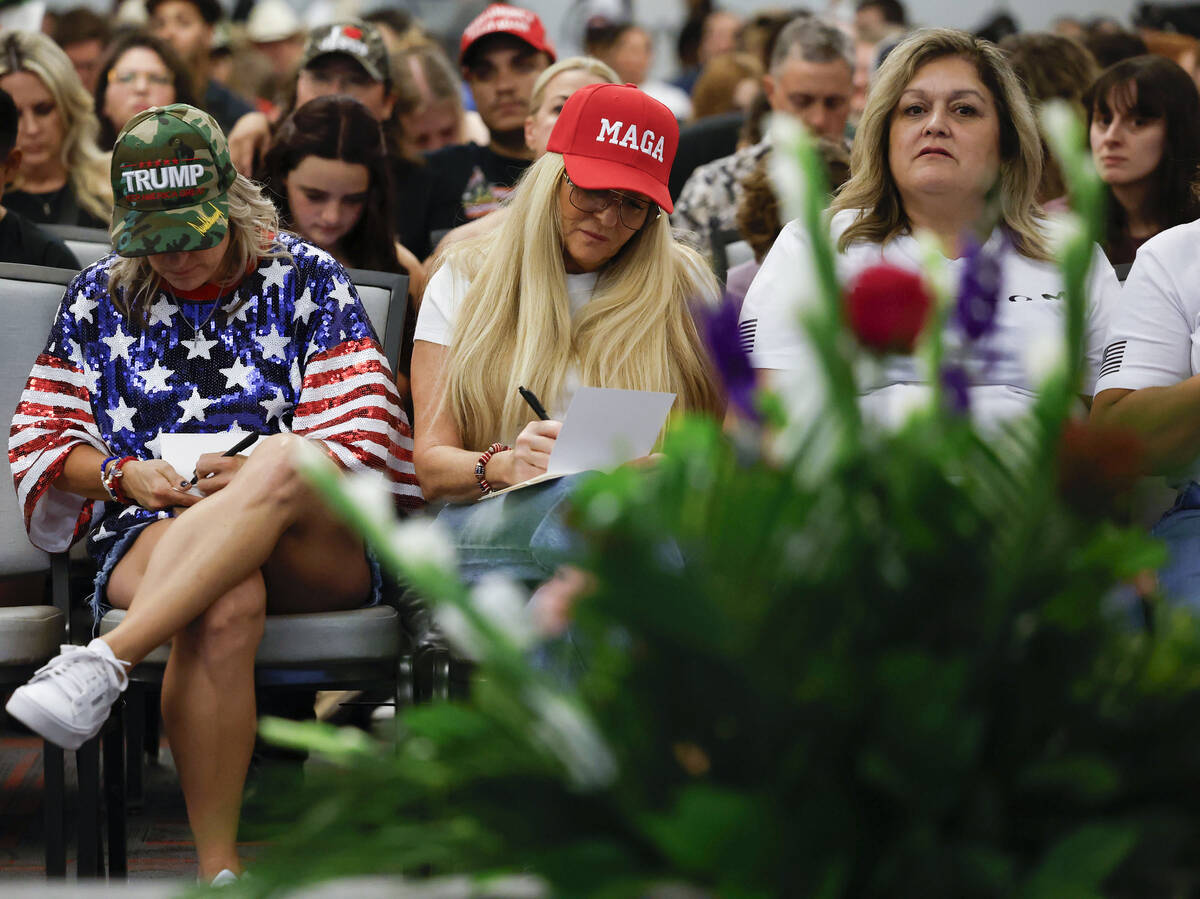 Attendees write letters of condolence during a vigil for Charlie Kirk hosted by Turning Point a ...