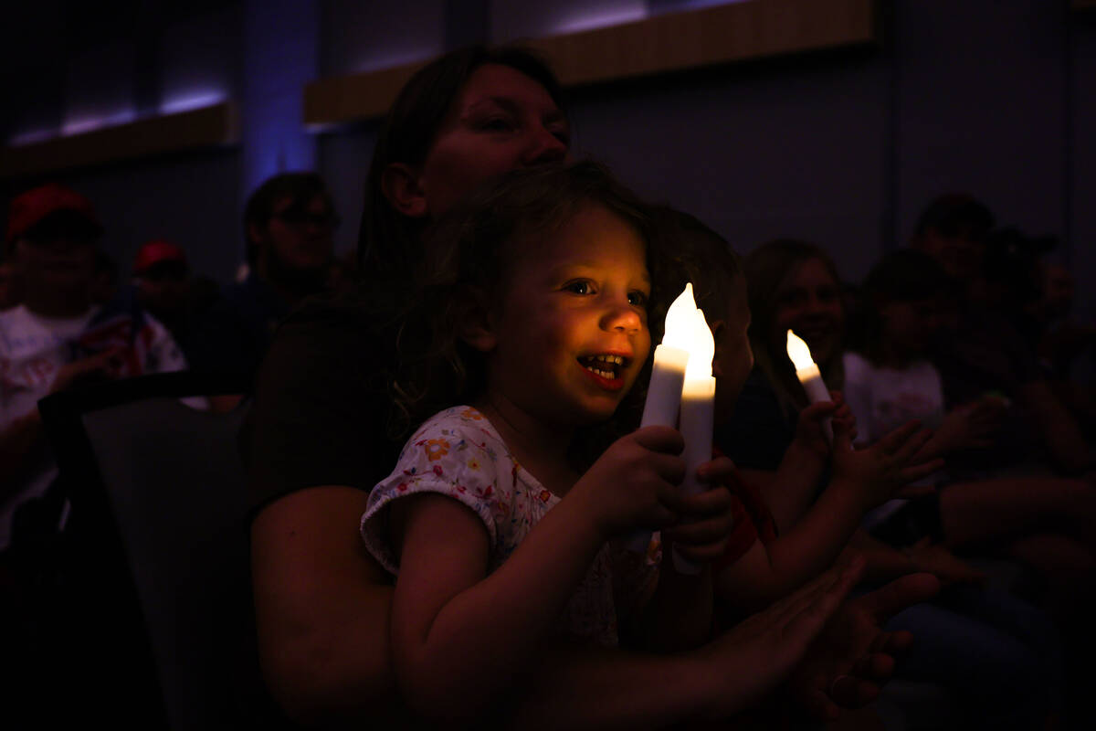 Fiona Bachman, 3, holds candles during a vigil for Charlie Kirk hosted by Turning Point at the ...