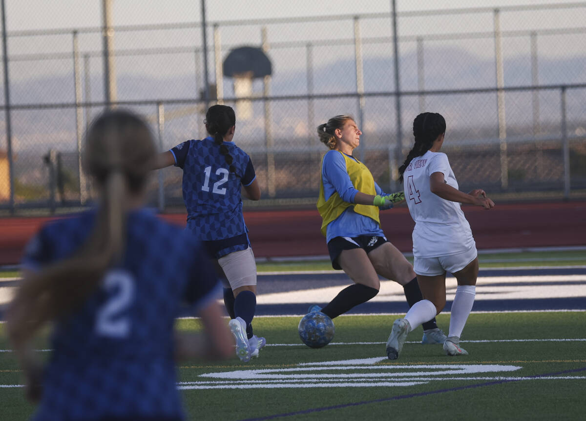 Arbor View's Sophia Sachs (4) kicks the ball around Centennial goalkeeper Madelyn Hartman ...