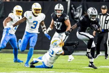 Raiders running back Ashton Jeanty (2) breaks. Tackle by Los Angeles Chargers safety Alohi Gilm ...