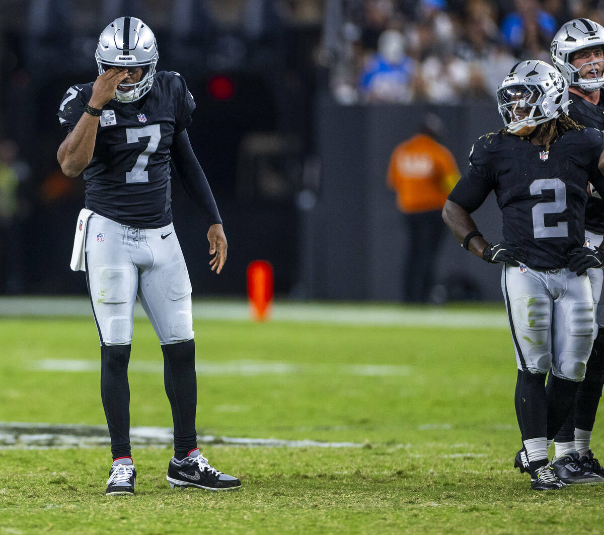 Raiders quarterback Geno Smith (7) takes a minute after another shot to the turf from the Los A ...