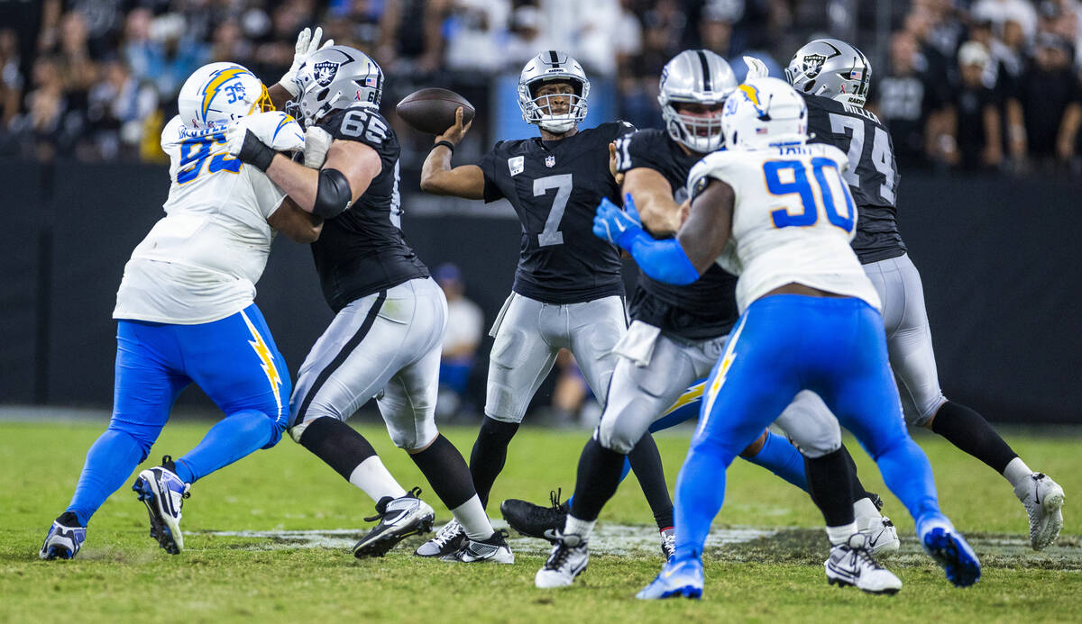 Raiders quarterback Geno Smith (7) looks to pass against the Los Angeles Chargers during the se ...
