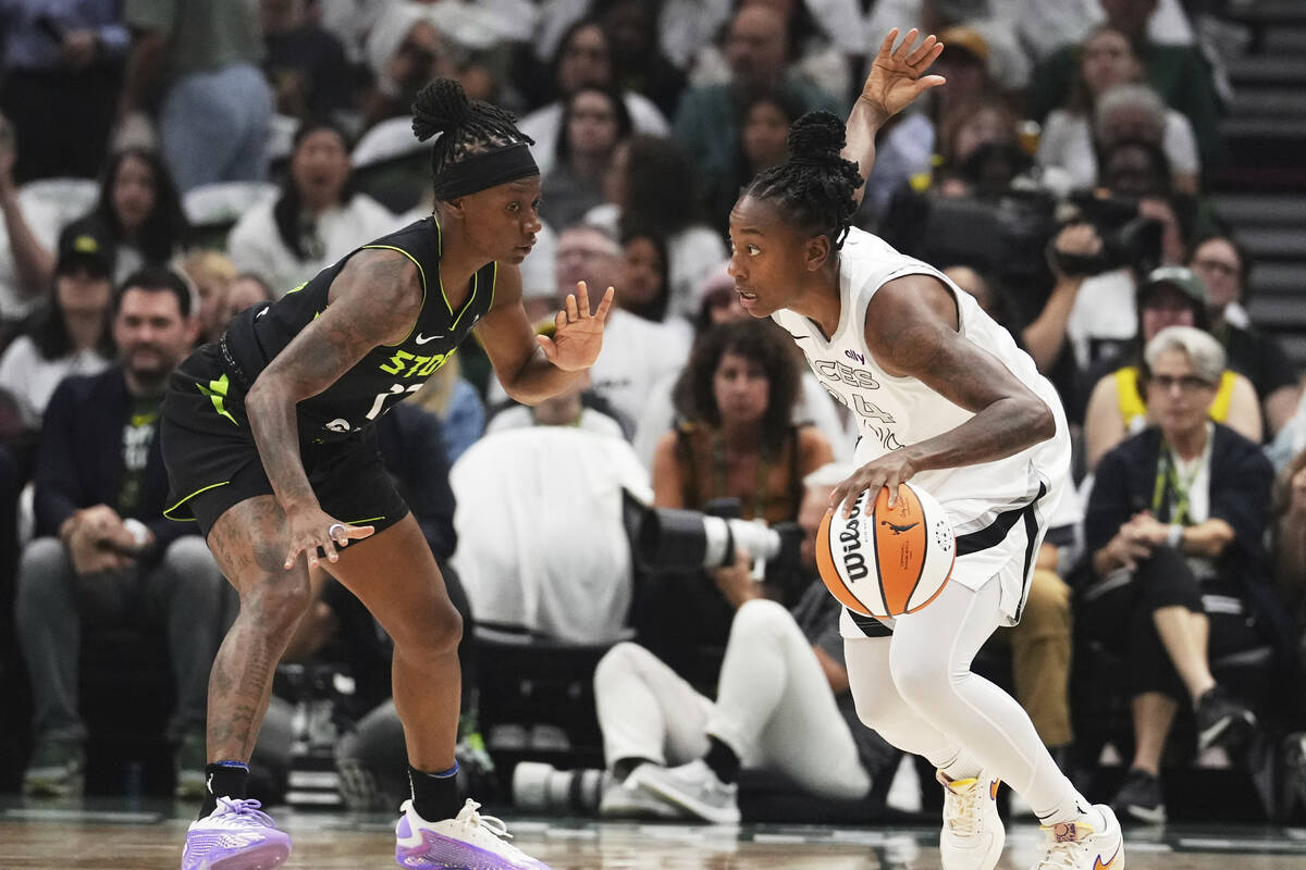 Las Vegas Aces guard Jewell Loyd, right, tries to move around the defense of Seattle Storm guar ...