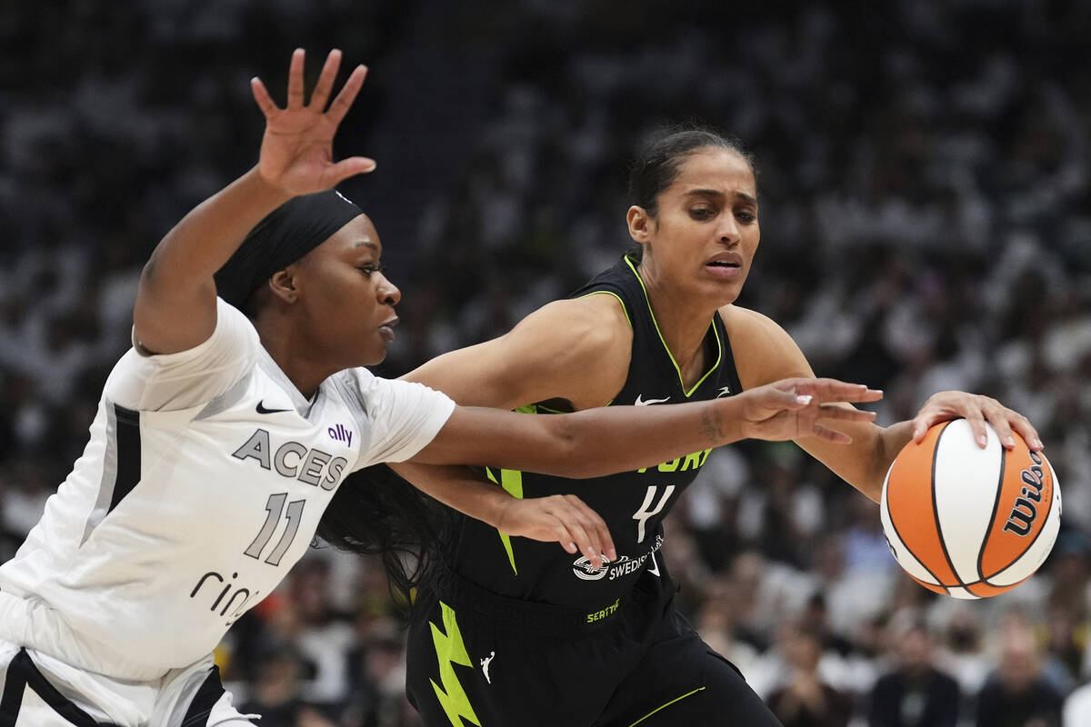 Seattle Storm guard Skylar Diggins, right, drives against Las Vegas Aces guard Dana Evans (11) ...