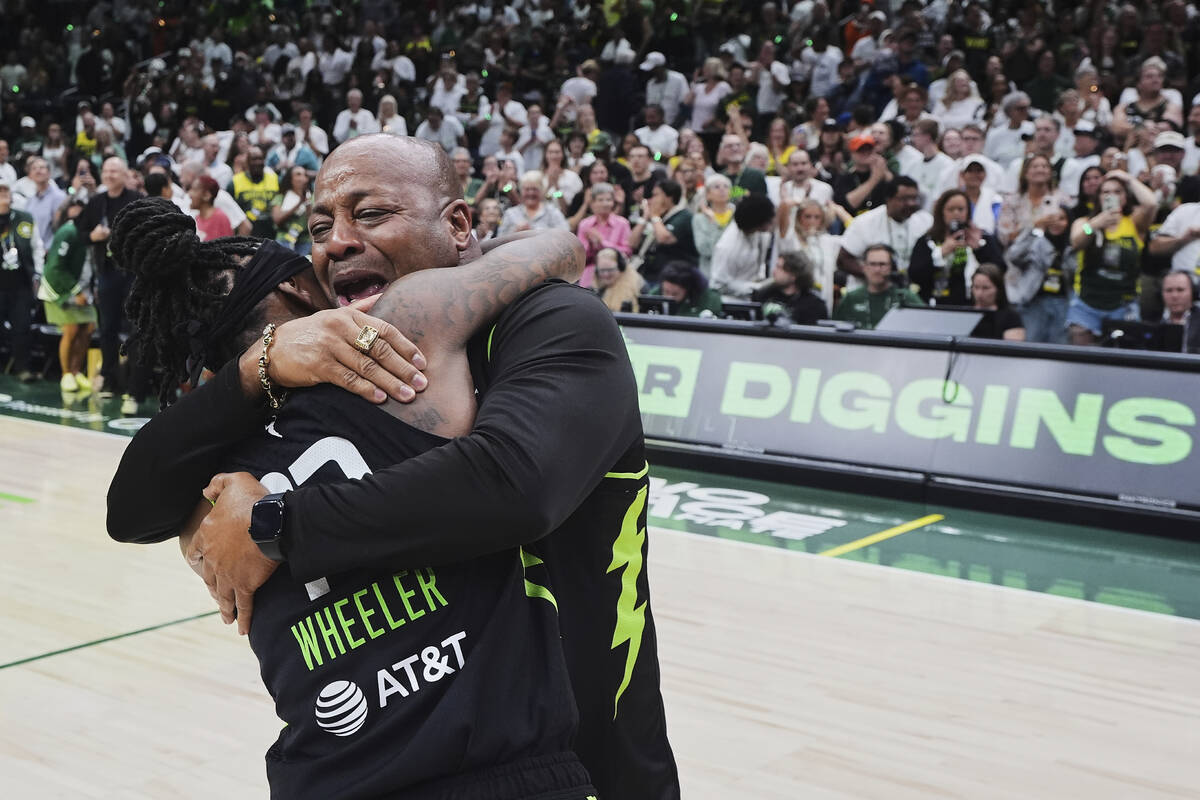 Seattle Storm guard Erica Wheeler hugs her father John Wheeler, facing, as she celebrates a win ...