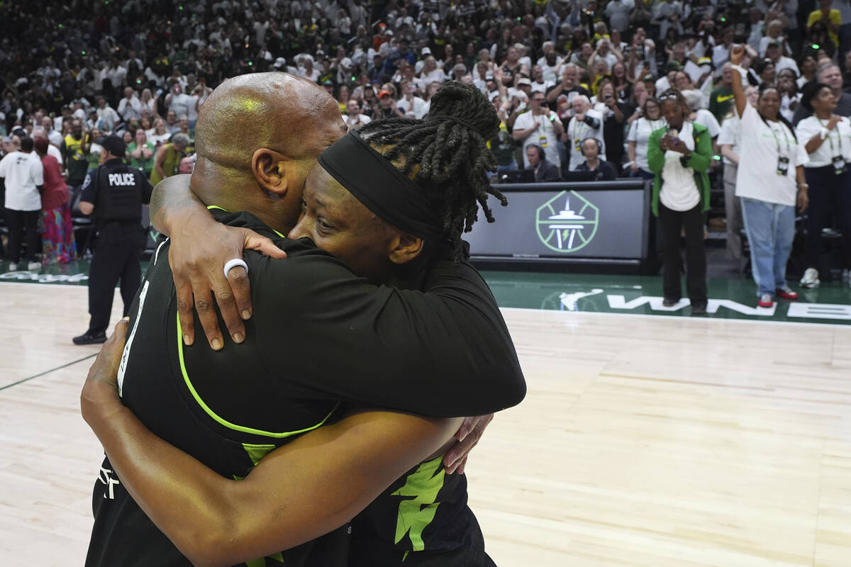 Seattle Storm guard Erica Wheeler hugs her father John Wheeler as they celebrate a win over the ...