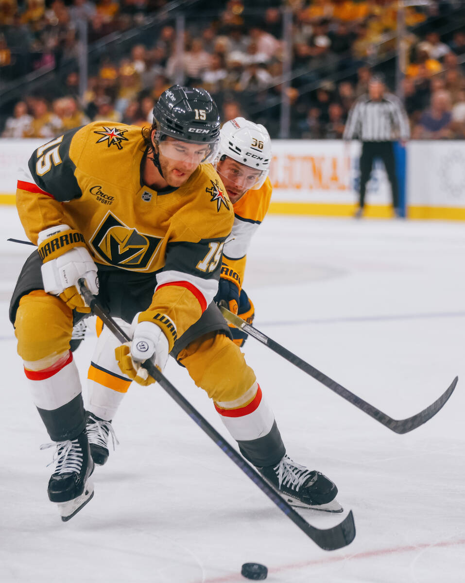 Golden Knights defenseman Noah Hanifin (15) skates with the puck as Nashville Predators left wi ...