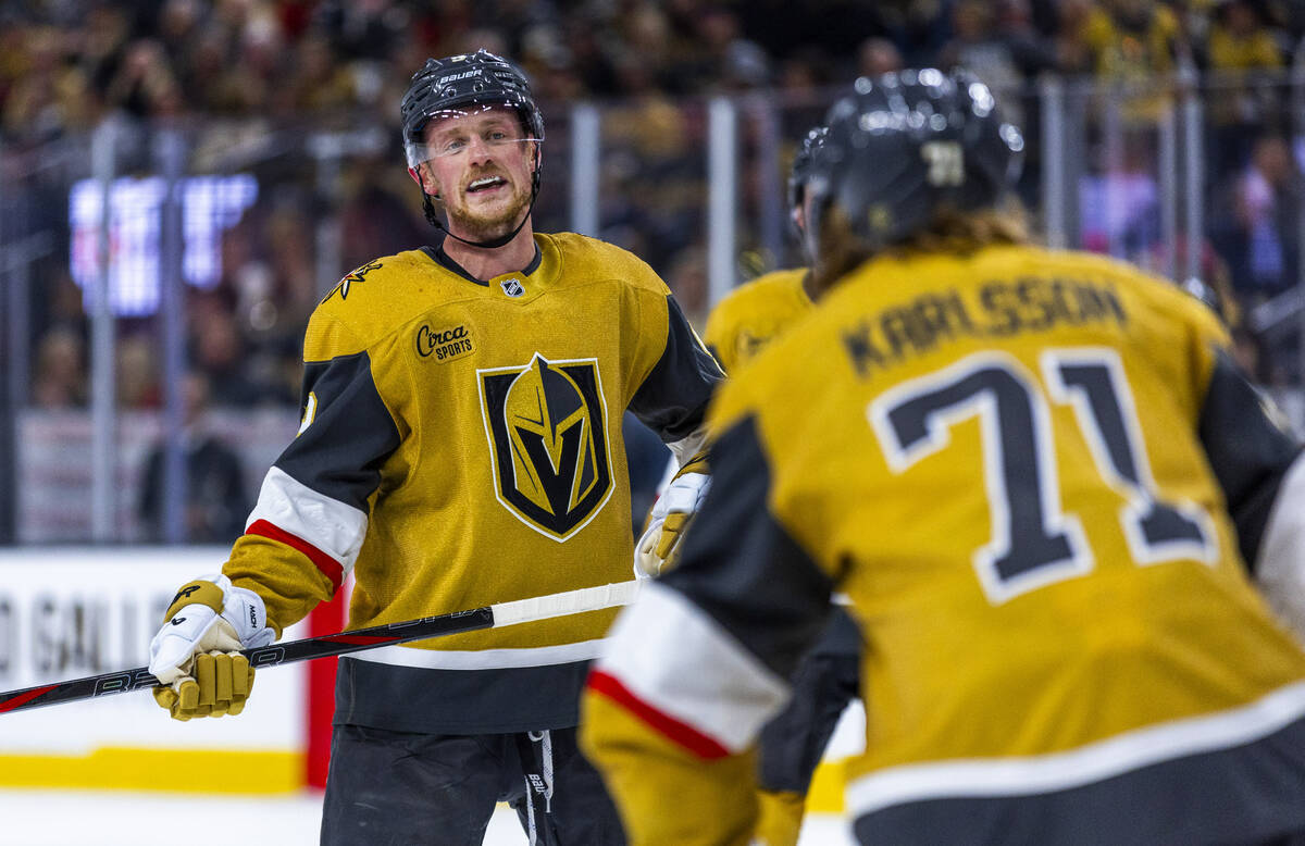 Golden Knights center Jack Eichel (9) talks with Golden Knights center William Karlsson (71) be ...