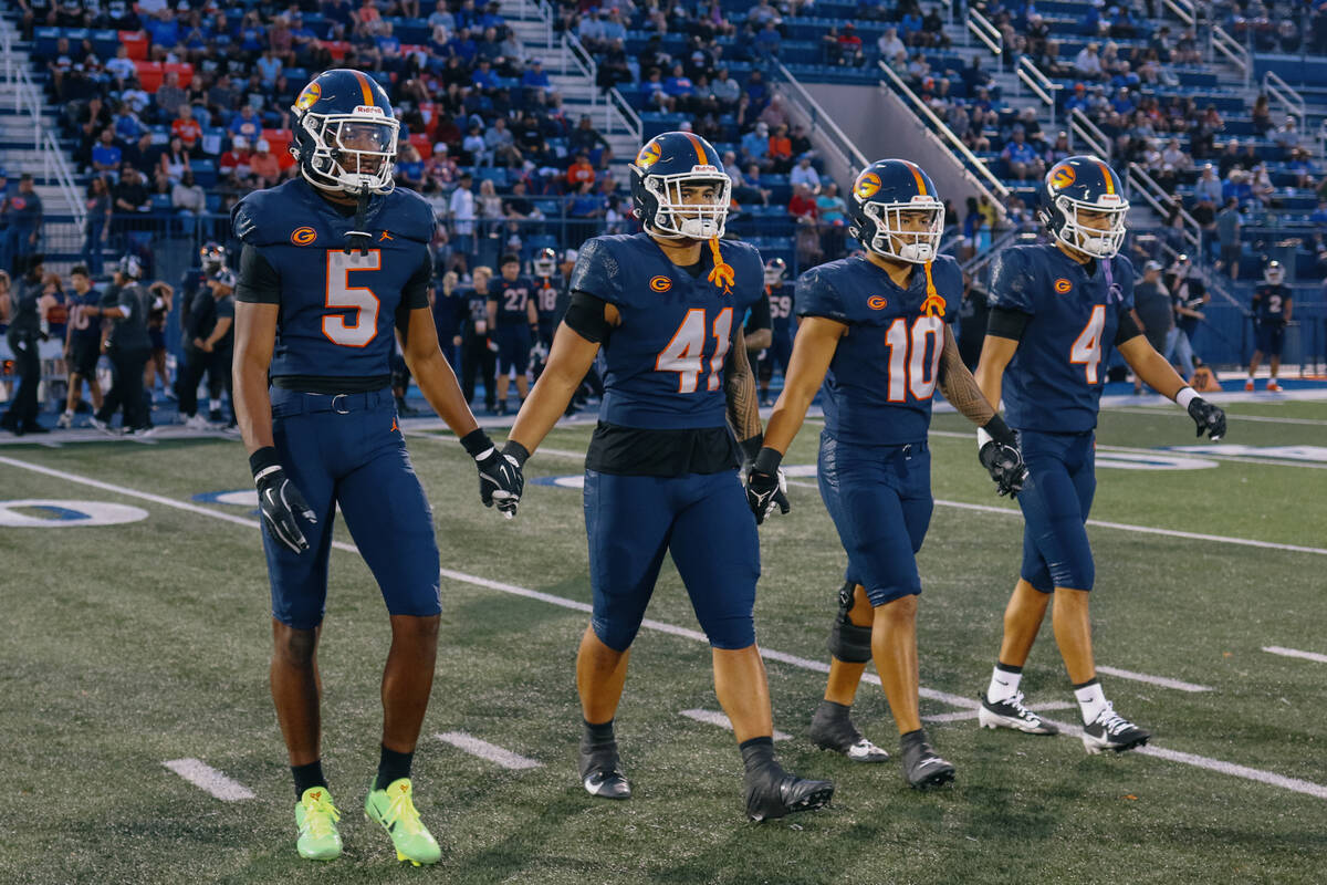 Bishop Gorman’s Jett Washington (5), Prince Williams (41), Tamatoa Gaoteote (10) and Kai ...