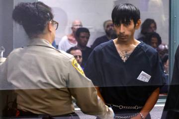 Jose Juarez,17, accused in the fatal park shooting Monday, is led out of a courtroom after his ...