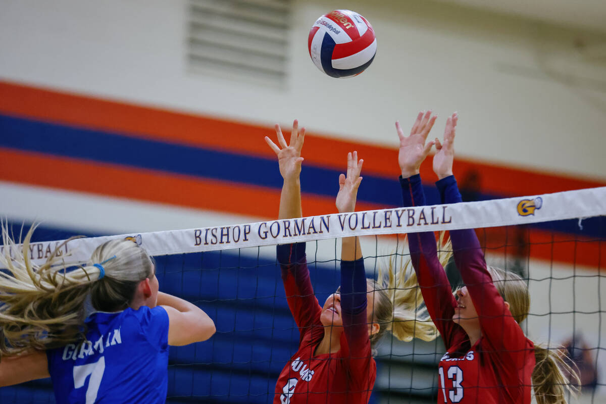 Coronado outside hitter Rachel Purser (9) and middle blocker Jamie Beckham (13) jump up to bloc ...