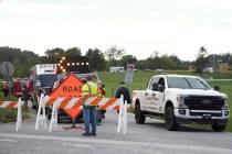 Emergency personnel block a road after a shooting involving police officers on Wednesday, Sept. ...
