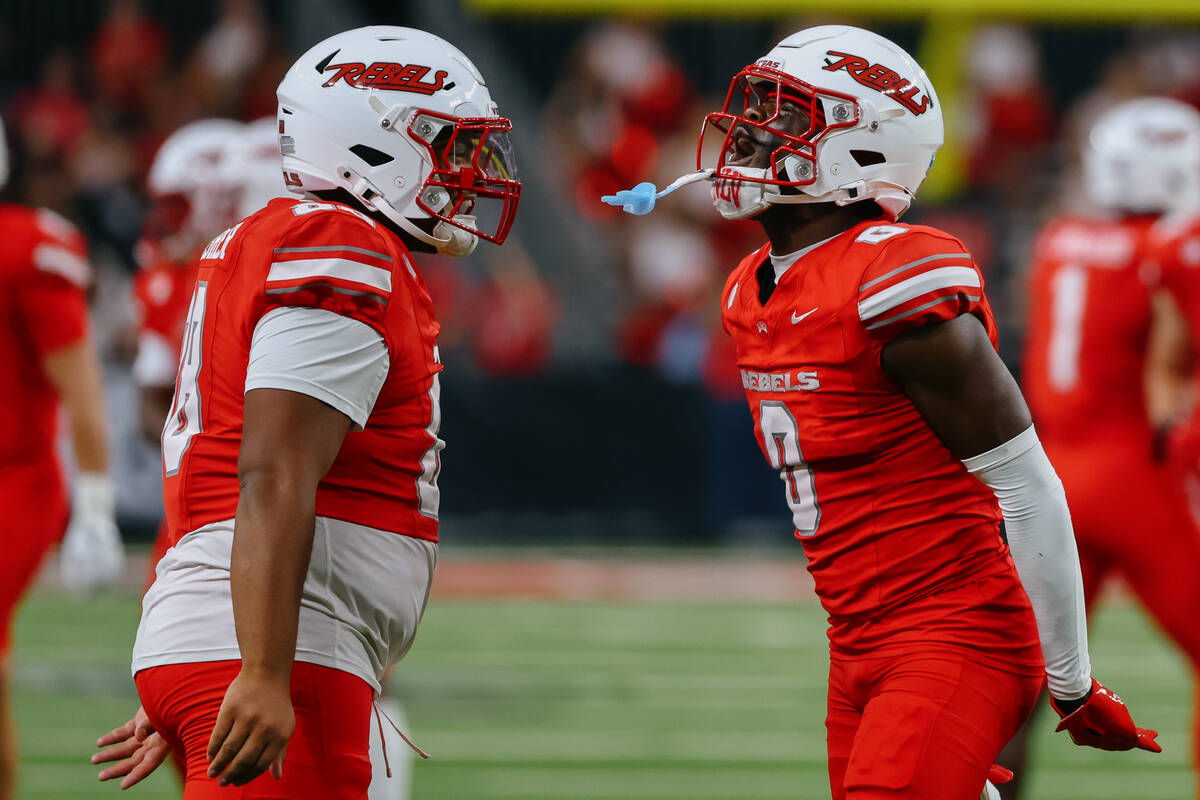 UNLV defensive lineman Mo Abbasher (88) and UNLV defensive back Laterrance Welch (0) celebrate ...