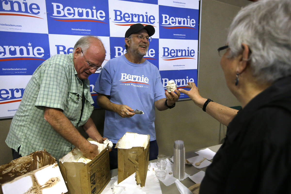 Ben & Jerry's co-founder Ben Cohen, left, and fellow co-founder Jerry Greenfield, center, scoop ...