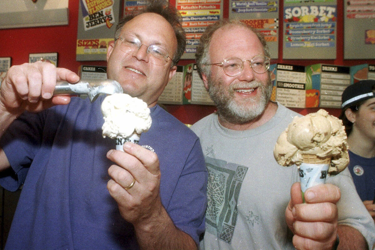 Jerry Greenfield, left, and Ben Cohen scoop ice cream cones during their 20th anniversary party ...
