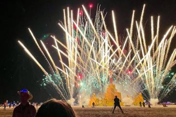 A security guard keeps people back during the annual Burning Man Festival on Sept. 4, 2023. (Ju ...
