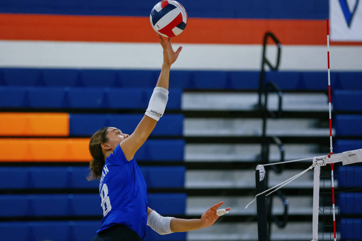 Bishop Gorman outside hitter Ayanna Watson (8) tips the ball during the volleyball game against ...