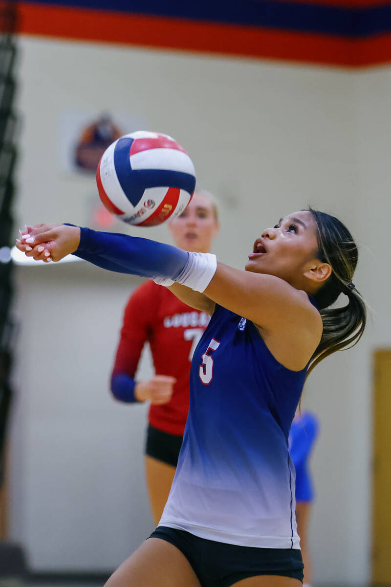 Coronado libero Isabelle Guerzon (5) passes an unexpectedly high ball during the volleyball gam ...
