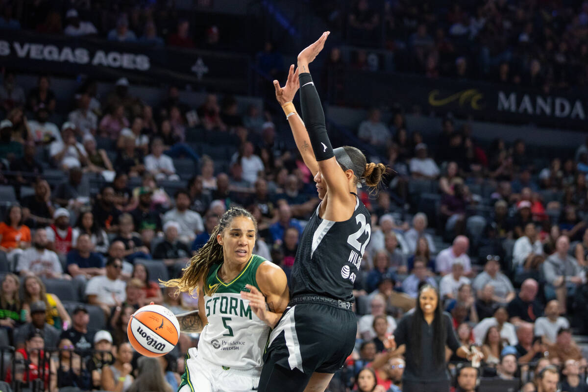 Seattle Storm forward Gabby Williams (5) attempts to naviagate past Las Vegas Aces center A&#03 ...