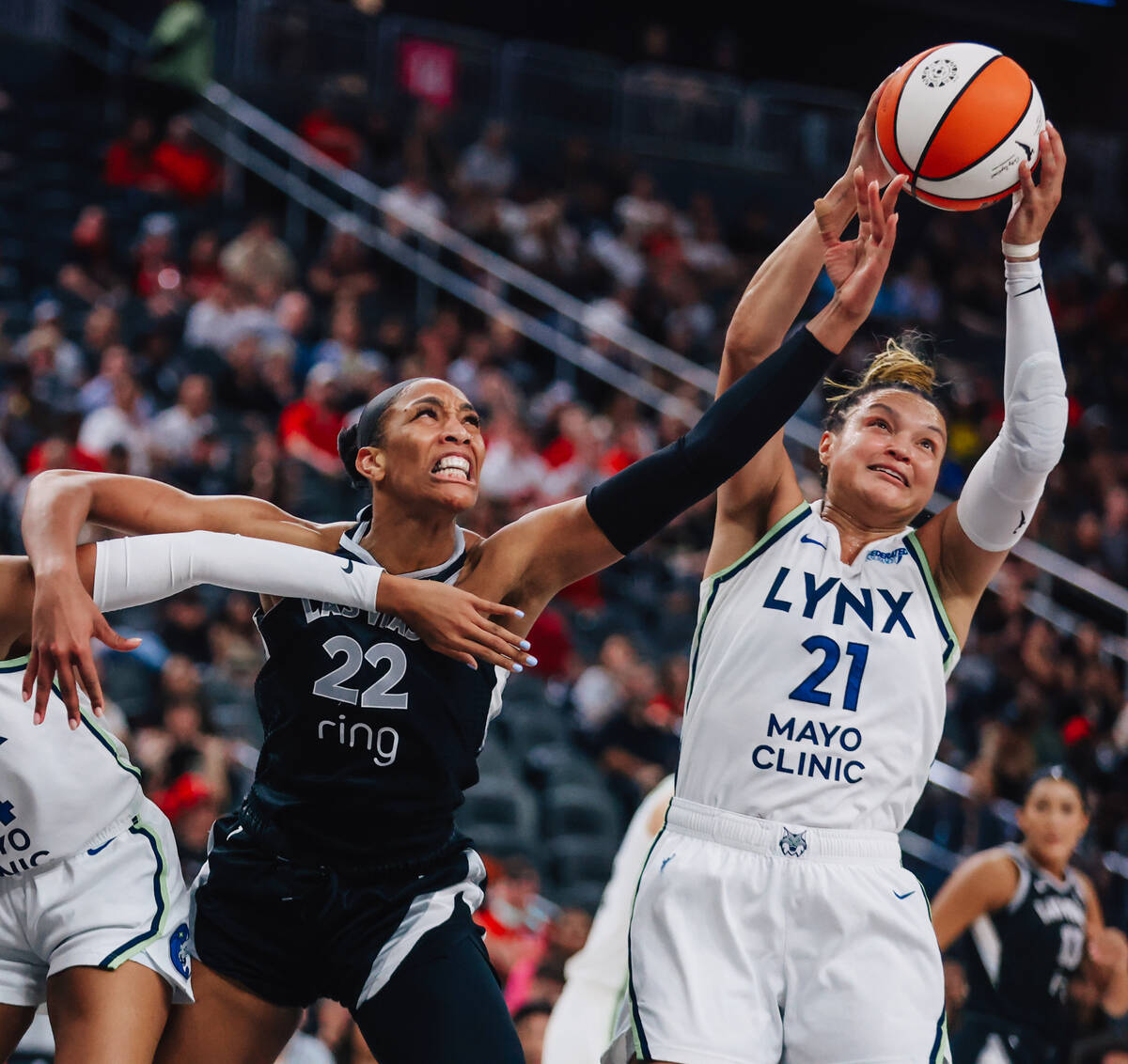Aces center A'ja Wilson (22) reaches for the ball as Minnesota Lynx guard Kayla McBride (2 ...