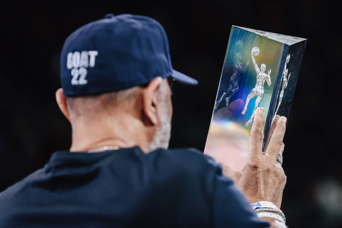 Roscoe Wilson Jr., A’ja Wilson’s dad, holds up her Defensive Player of the Year t ...