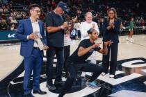 A’ja Wilson photobombs her Defensive Player of the Year trophy presentation during game ...