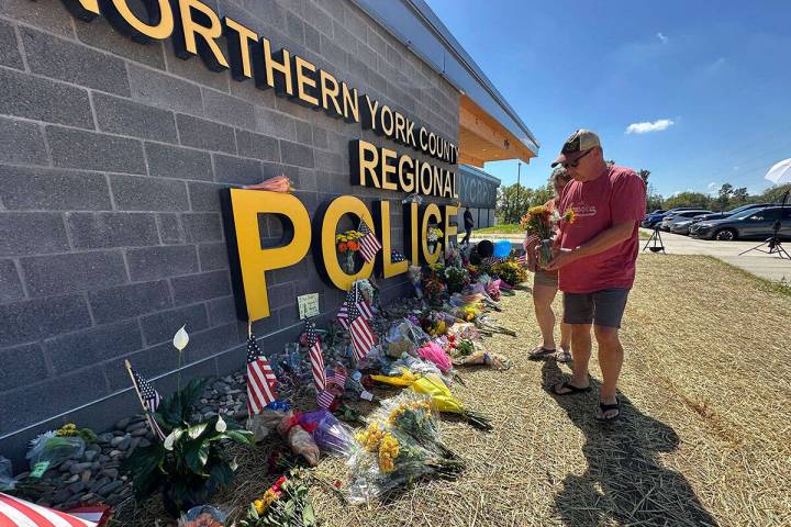 A memorial for police officers killed in a shooting is shown outside the Northern York County R ...