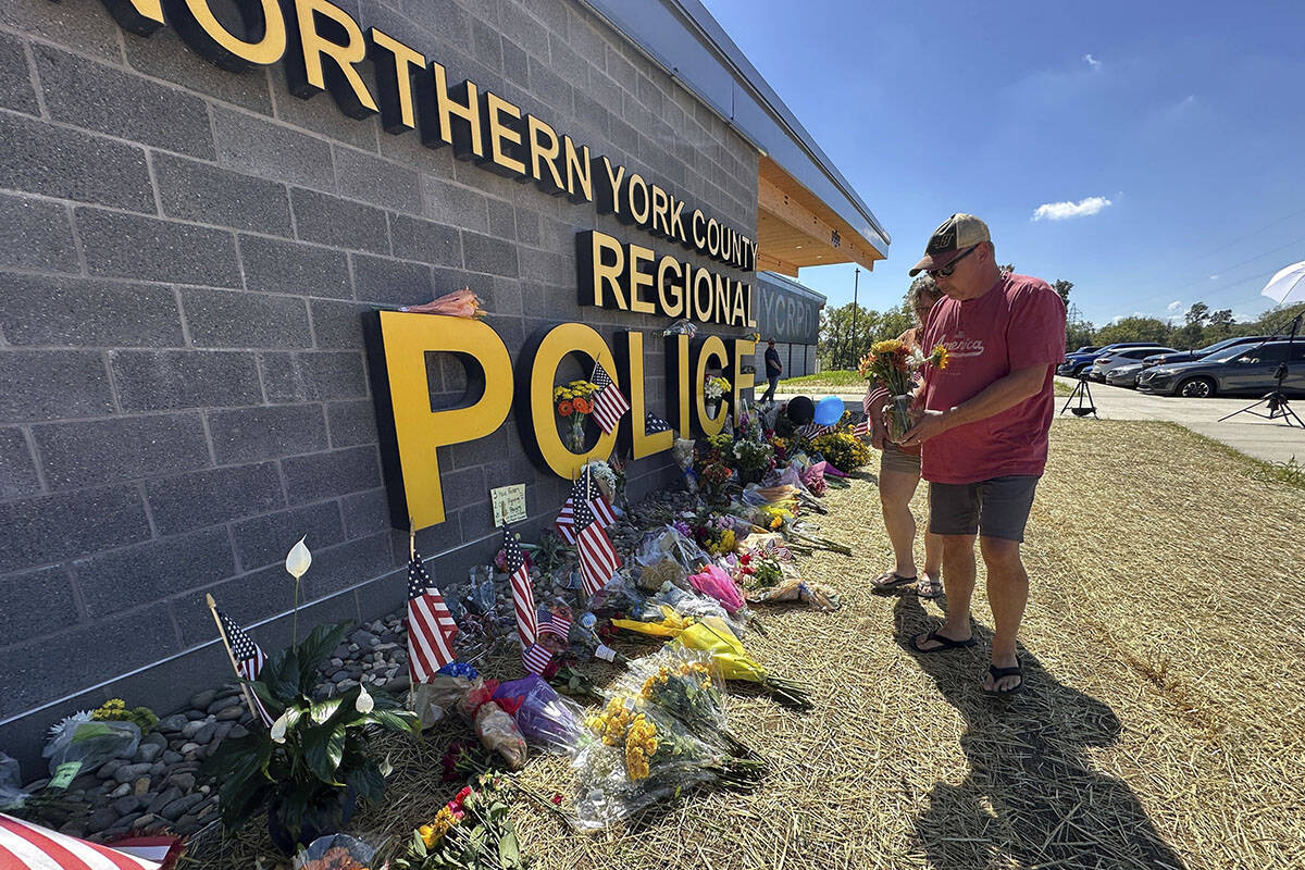 A memorial for police officers killed in a shooting is shown outside the Northern York County R ...