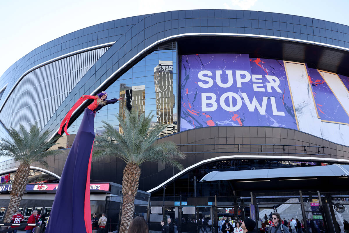 An entertainer performs for 49ers and Chiefs fans arriving at Allegiant Stadium in Las Vegas be ...