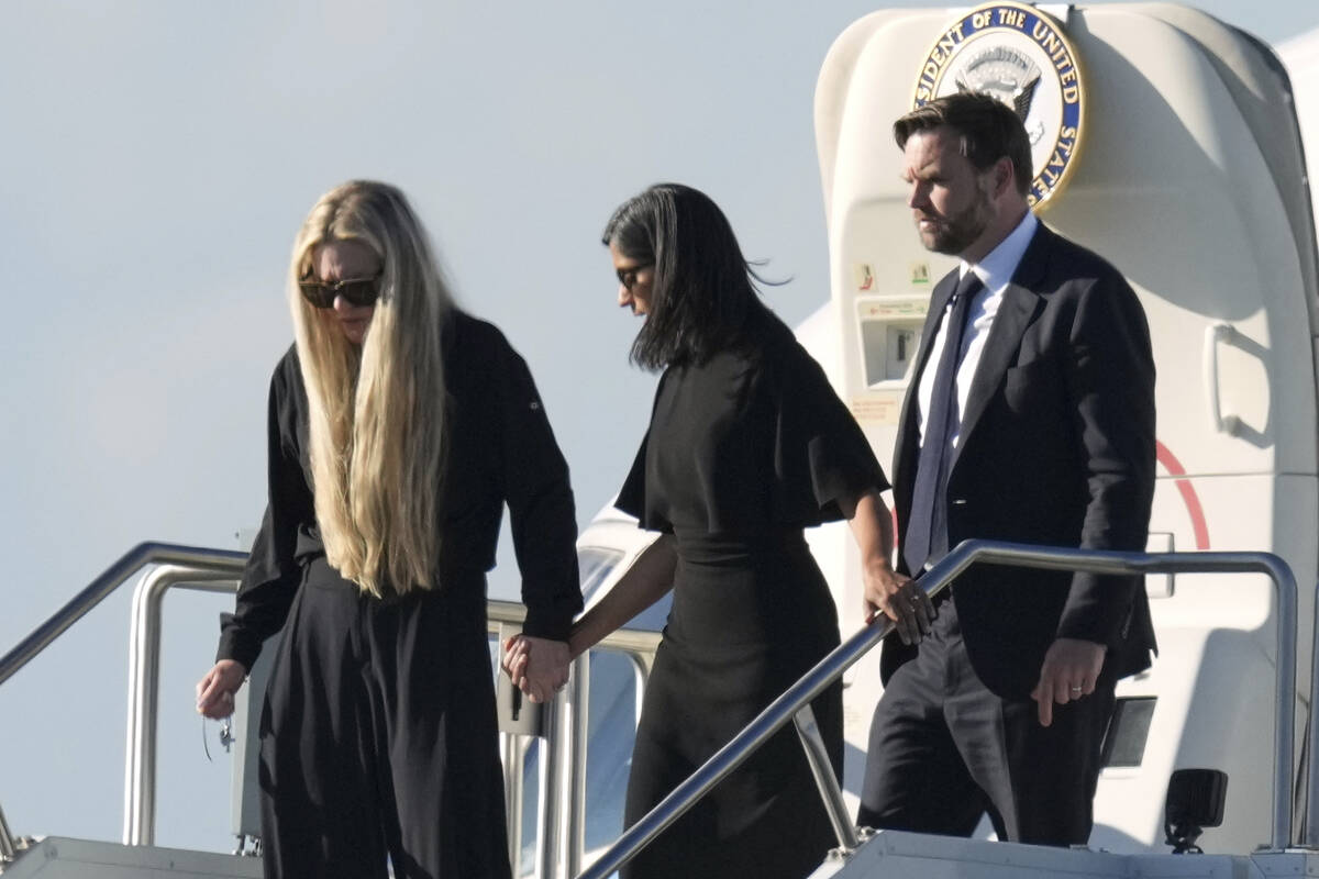 Vice President JD Vance, right, Second Lady Usha Vance, center, and Erika Kirk, holding a cross ...