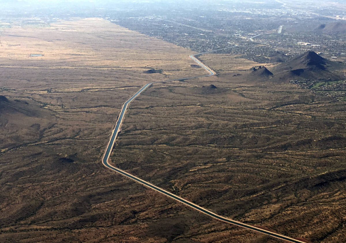 FILE - The Central Arizona Project canal runs through rural desert near Phoenix, Oct. 8, 2019. ...