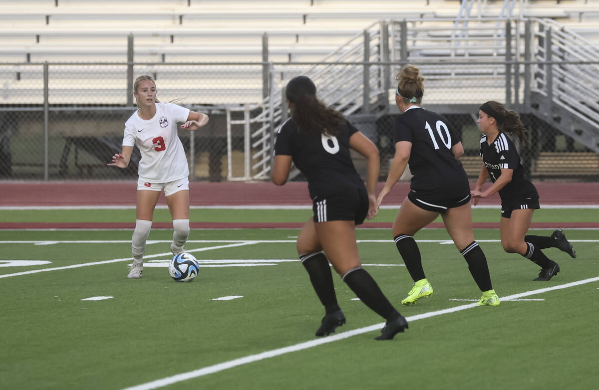 Coronado's Alexandra Milano (3) looks to kick the ball around Palo Verde defenders during ...