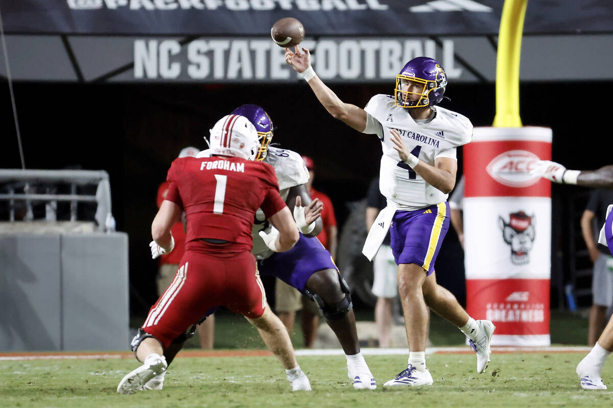 East Carolina quarterback Katin Houser (4) throws the ball against North Carolina State during ...