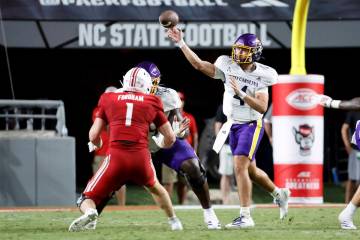 East Carolina quarterback Katin Houser (4) throws the ball against North Carolina State during ...